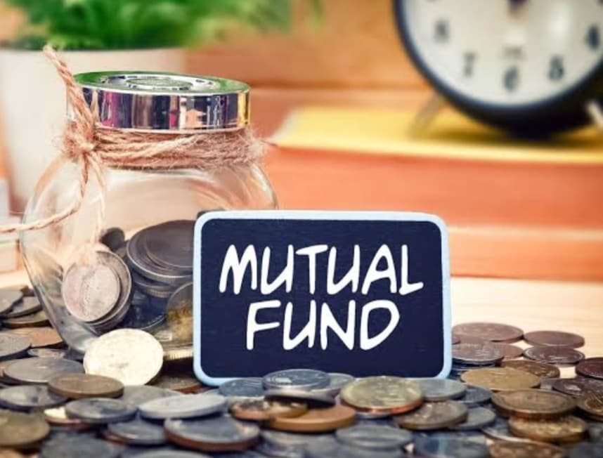 Jar filled with coins and a "Mutual Fund" sign, representing mutual fund investments, savings growth, and long-term wealth creation.